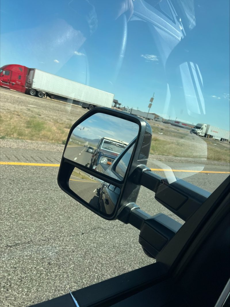 side mirror of Truck showing old Bronco